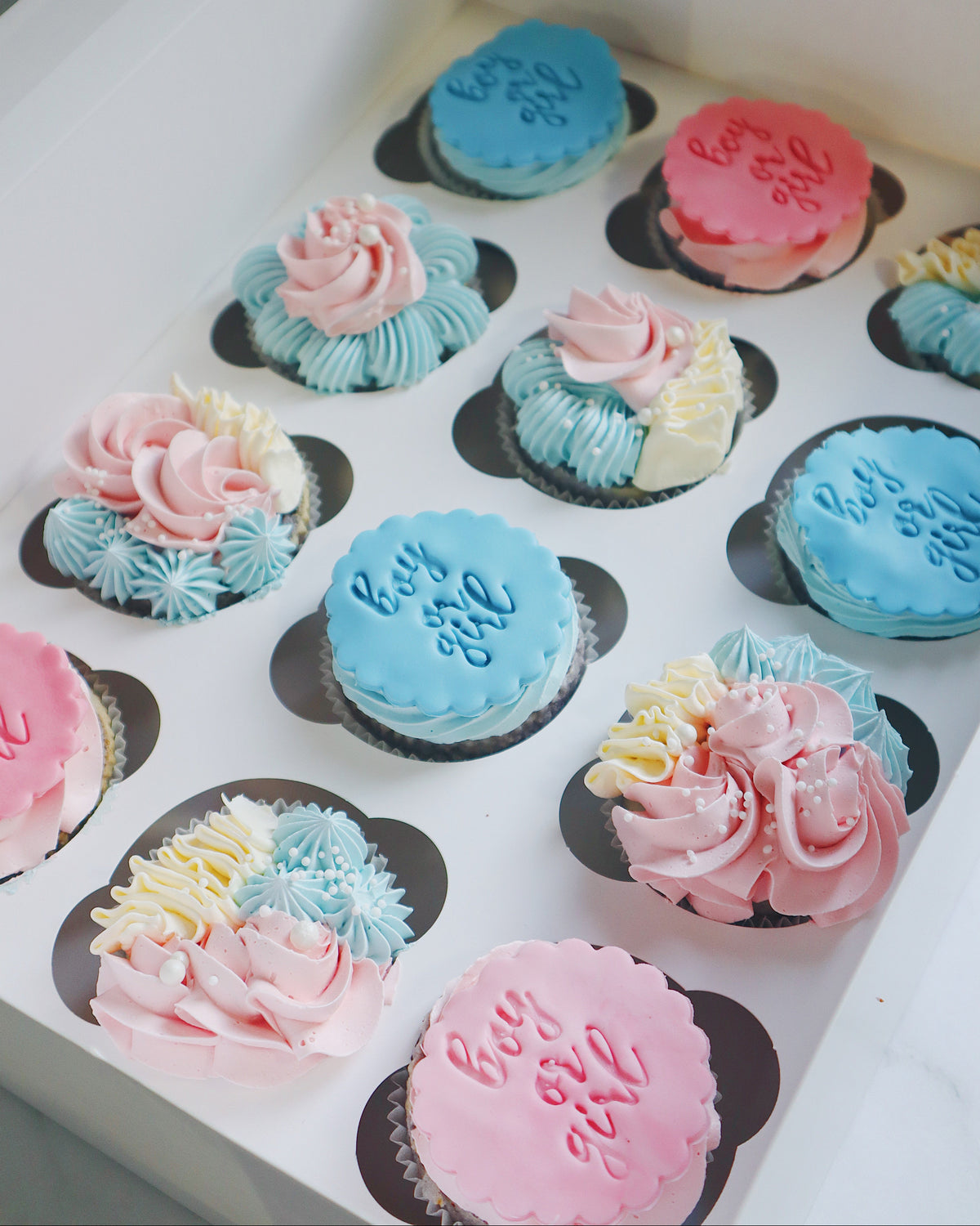 Assorted cupcakes with colorful frosting in a box