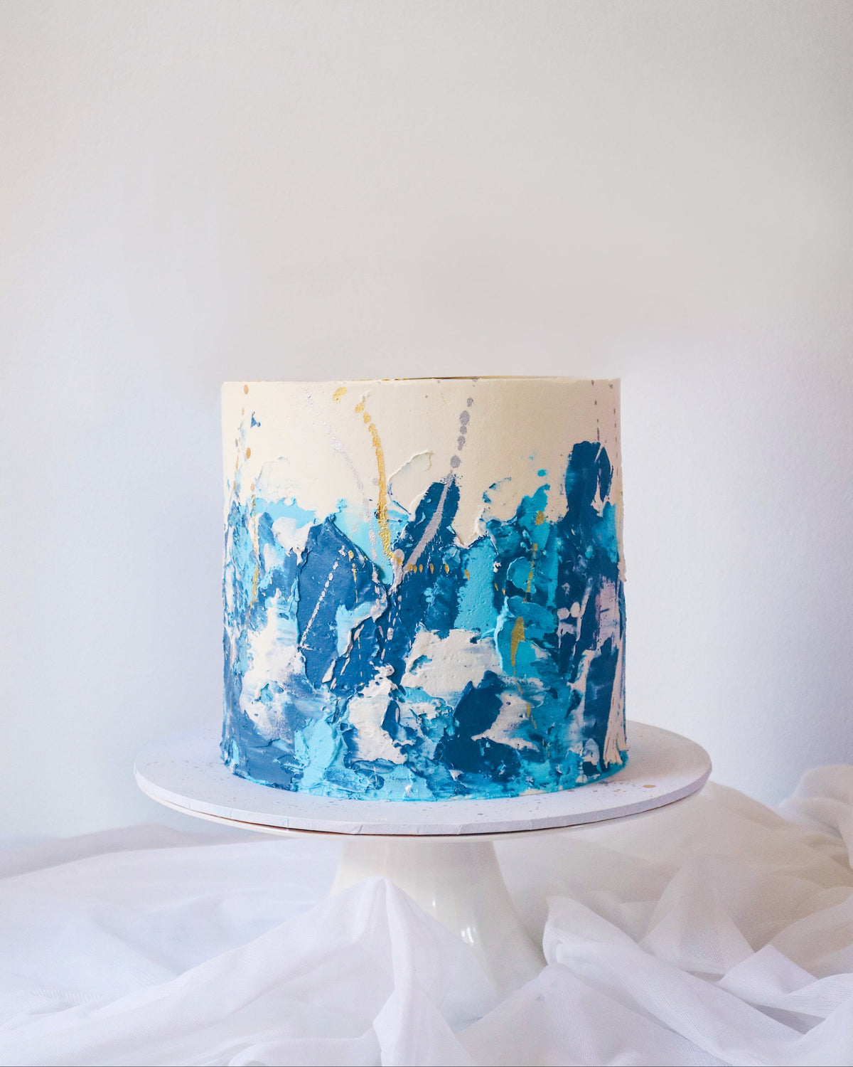 Cake with blue abstract design on a white background