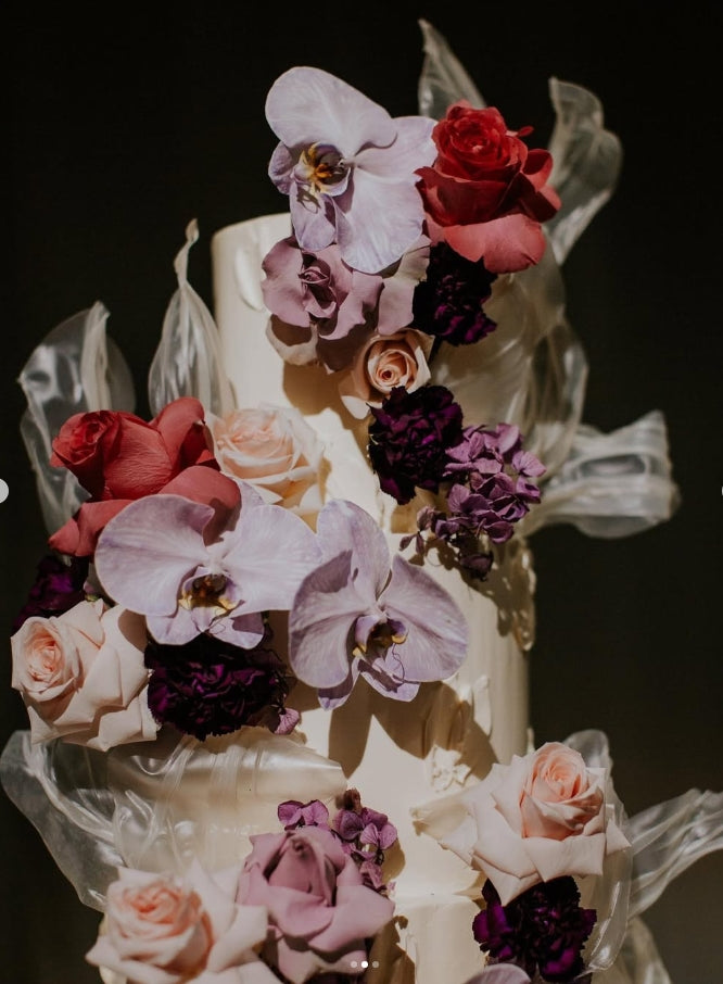 Decorative cake with colorful flowers on a dark background
