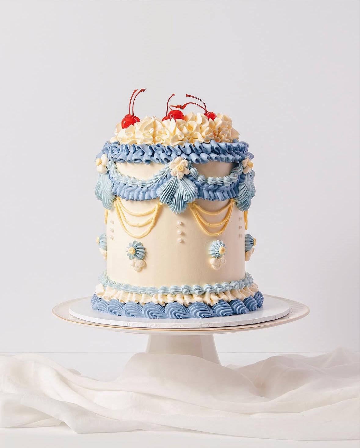 Decorative vintage cake with blue and gold accents on a white background